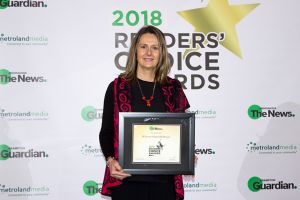 Dr. Kate holding her Best of Mississauga Award